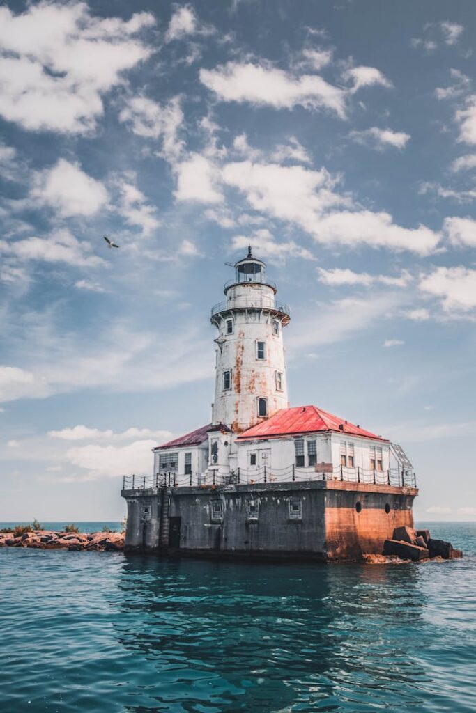 White Lighthouse Under Cloudy Sky